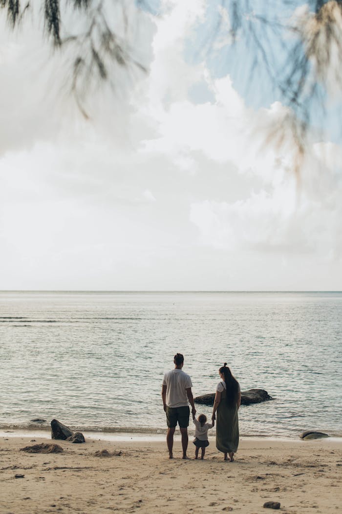 A family enjoys a tranquil day at the beach, highlighting togetherness and love.